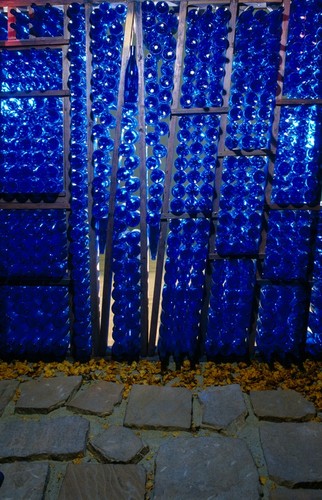 Abode: Sanctuary for the Familia(r): detail of blue glass bottles