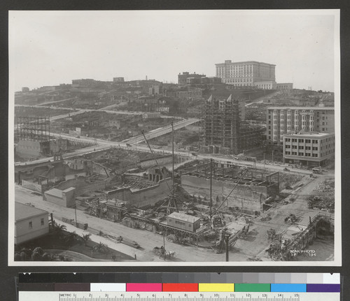 [View looking northwest toward Nob Hill from above circa Stockton and Geary Sts. during reconstruction. Union Square, lower left; Temple Emanu-el, right center; Fairmont Hotel atop hill.]