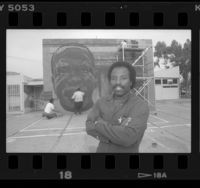Richard Wyatt with his mural of Cecil Fergerson at the Watts Towers Arts Center, Calif., 1989
