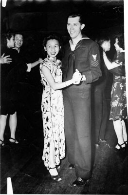 [Men and women dancing at a social gathering in Chinatown]