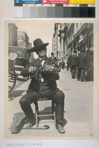 A sidewalk fiddler--one of many. Ca. 1905