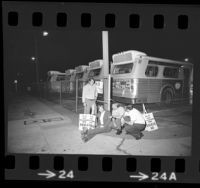 Five RTD bus drivers waiting with strike picket signs at bus yard in Los Angeles, Calif., 1974