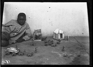 African boy with figurines he made, Lemana, South Africa, ca. 1906-1915