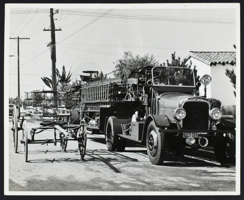 Modern fire truck and old horse-drawn fire cart at Station No. 12, 6509 Gundry