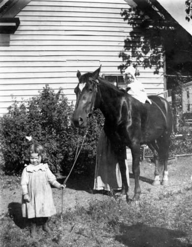 Girl and Infant with a Horse on Spanish Ranch