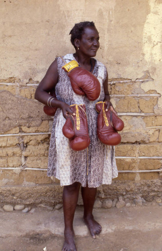 Woman with boxing gloves hanging from her neck, San Basilio de Palenque, 1976