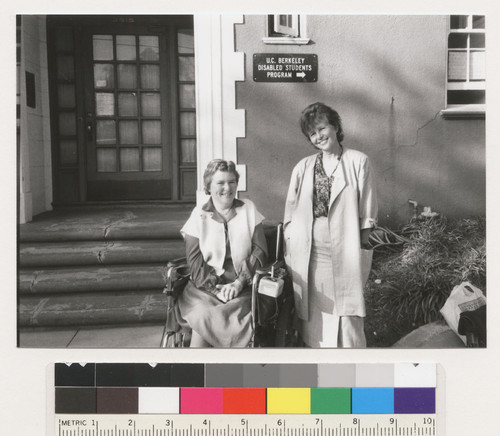 An unidentified woman and Susan O'Hara in front of the U.C. Berkeley Disabled Students Program building