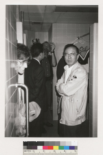 Unidentified people standing in a tiled room