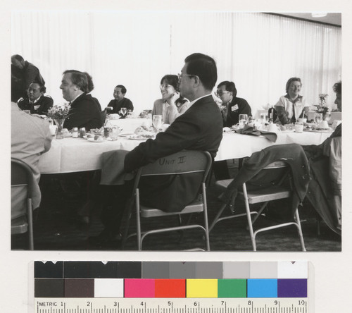 Kurt Lauridsen, Mary Ann Skrivanich, Susan O'Hara and unidentified peoplesitting at a table, they are looking at something and smiling