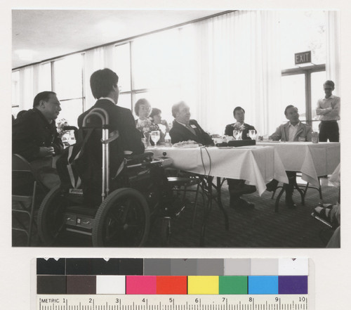 Kurt Lauridsen, Sharon Bonney and unidentified people sitting at a table, looking at something