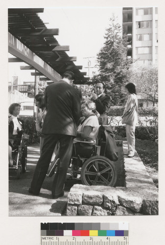 Susan O'Hara and unidentified people mingling