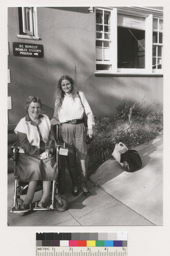 An unidentified woman and Susan O'Hara in front of the U.C. Berkeley Disabled Students Program building