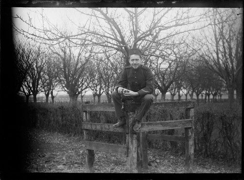 [Man sitting on fence.] [negative]