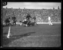 Football Iowa defenders tackling a U.S.C. back at the Coliseum in 1925