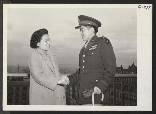 Mrs. Duayne M. Kimball of 820 Humboldt Street greets her brother, 1st Lt. Howard Y. Miyake, wounded Japanese war veteran
