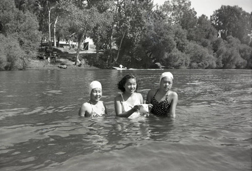 Three women at the river