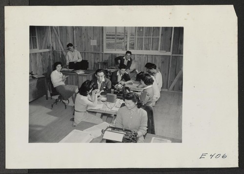 Evacuees on the newspaper staff at work in their office. Photographer: Parker, Tom Denson, Arkansas