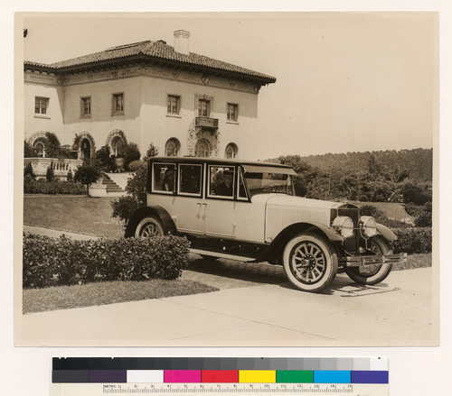 Doble five passenger sedan in front of estate, front three quarter view