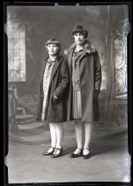 Portrait of two girls wearing coats, c. 1928