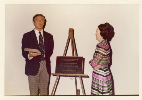 Dr. William Banowsky dedicating the Tyler Canpus Center; the Bronze Plaque is on a tripod stand and Mrs. Alice Tyler is seated to the Right. (Color)