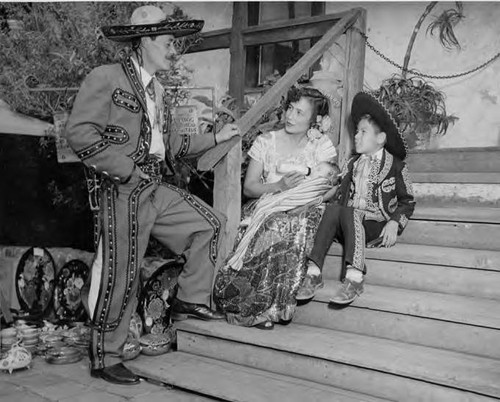 Mr. and Mrs. Santana and children in Mexcio costume on steps of Avila Adobe
