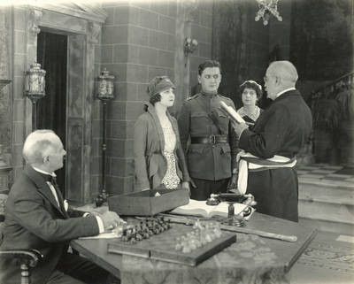 Reginald Barlow seated, Vivienne Osborne, Thomas J. Carrigan, James P. Laffey, Love's Flame, 1920