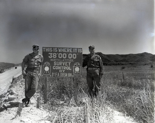 Williams and Major Hanies posing with 38th Parallel sign