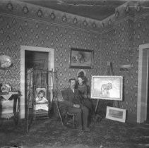 Interior view of a couple with a child seated in a living room in Fair Oaks