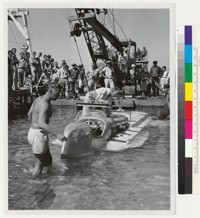 Crane attached to sinking speedboat, Lake Tahoe