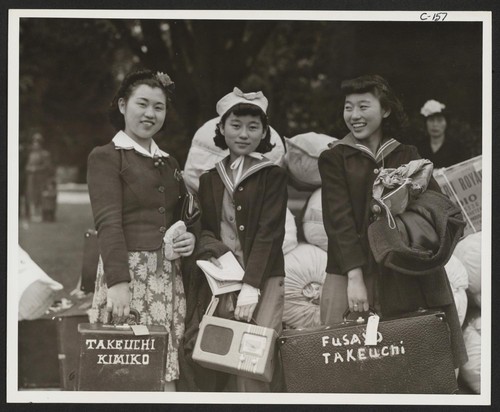 Three sisters, all high school students, awaiting evacuation bus. Evacuees of Japanese ancestry will be housed in War Relocation Authority centers for the duration. Hayward, California