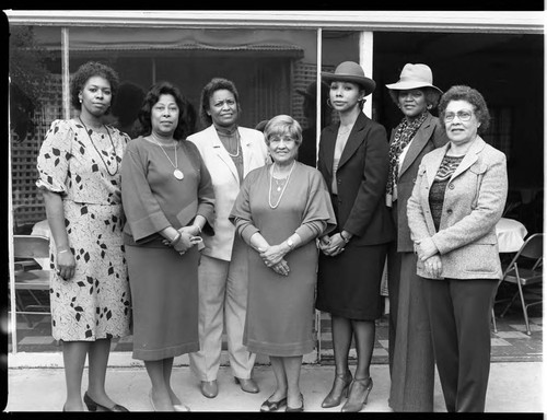 Seven woman posing outside of a meeting room, Los Angeles, 1985
