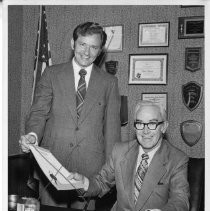 Mayor Richard Marriott handing Larry G. Whitish (left), Sacramento area manager for Heinz U.S.A., a proclamation proclaiming the week of August 10, 1975 as Sacramento Salad Week