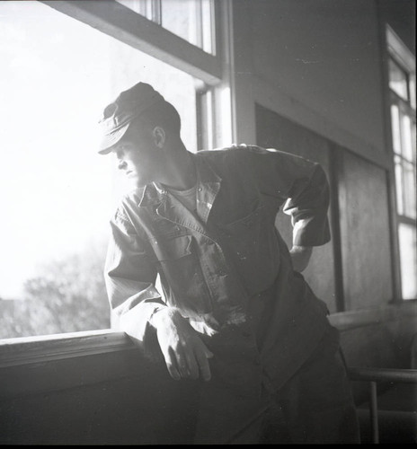 Soldier posing by a window at Fort MacArthur
