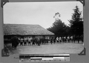 Missionary Gemuseus with students, Rungwe, Tanzania, ca. 1898-1914