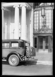 Car with trunks on back in front of Biltmore Hotel, Los Angeles, CA, 1930