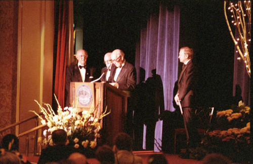 Howard White, Julian A. Virtue, Arnold O. Beckman, and Dr. James Wilburn at the podium