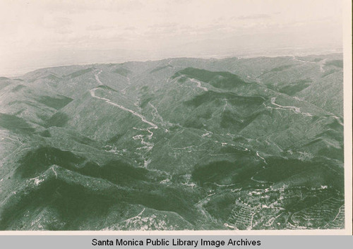 Aerial view of Los Liones Canyon (on the left) and Santa Ynez Canyon (on the right) with a view of Paseo Miramar in Pacific Palisades, Calif