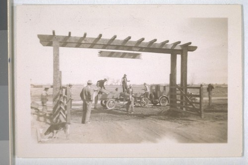 Spring, 1936, Kern County. Arvin Migratory Labor Camp - Campers volunteer labor in improving entrance to camp