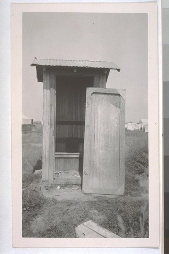 July, 1936, Kern County, Kern Lake District. One-hole privy, on one of the large scale ranches in Kern Lake District, probably the Hutcheson Ranch. Hutcheson is a millionaire living in Bakersfield. Note the filth on the floor and the door broken off