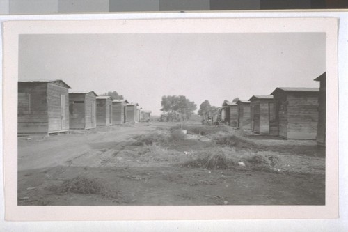 July, 1936, Kern County, Kern Lake District. This is a typical camp for families of farm laborers in the Kern Lake District. Note one-room cabins, no windows, unpainted, and unsightly