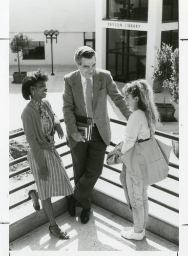 Dr. Paul Randolph with two students outside Payson Library
