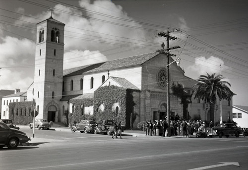 Mexican workers shanding in front of church