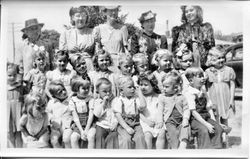 Unidentified group of Kindergarten age girls and boys with five women standing behind them, about 1940