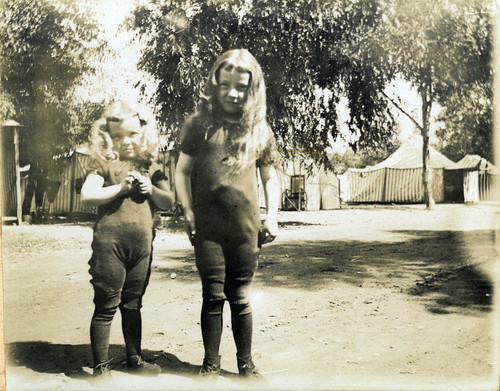 Two young girls standing outdoors at Tent City, Coronado, Calif. c. 1904