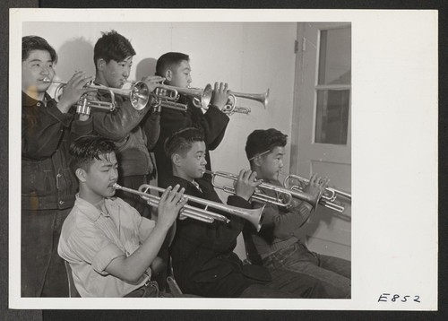 A part of the brass section of the High School Band, at the Rohwer Center. The students learning to play instruments for the band are former Californians, who, with their parents, were evacuated from strategic west coast areas. Photographer: Parker, Tom McGehee, Arkansas