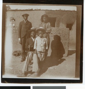 Jakob Lebele with family in front of a mud house, South Africa