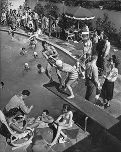 Young people swimming in and playing around a pool, 1940-1950