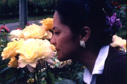 Patricia Whiting smelling a rose