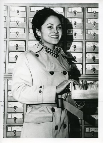 Patricia Whiting posing with card catalog at a library