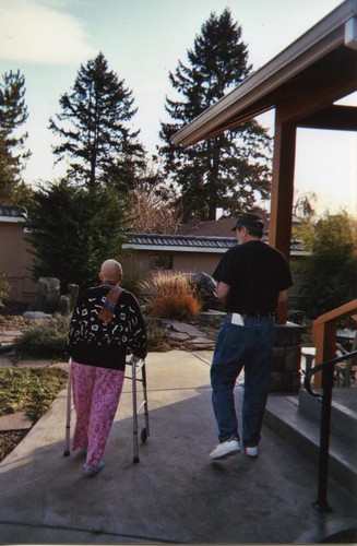 Patricia Whiting walking in courtyard with her brother